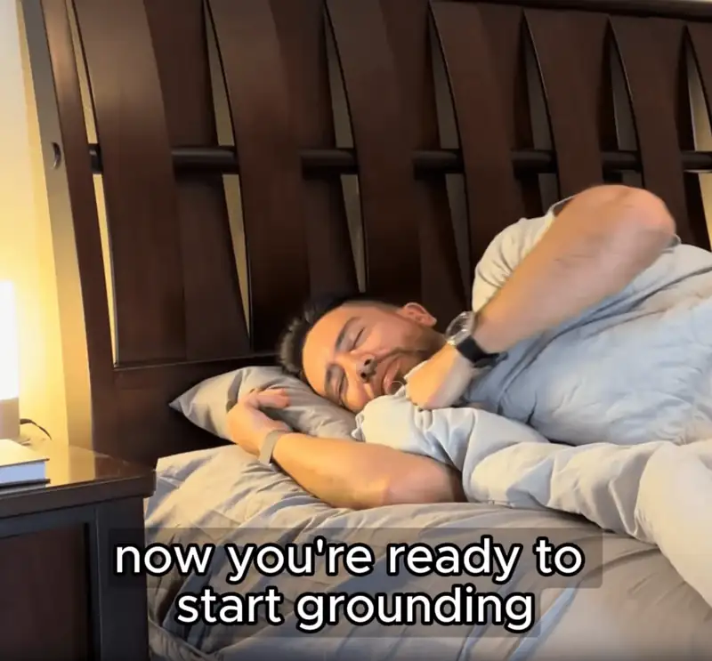 Man sleeping grounded on the Terra Grounding Bed Sheet